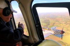 Bud riding a helicopter to Leiston Airfield and being escorted by a P-51