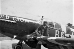 Crew Chief Otto Heino on the wing of P-51B Old Crow. Note Invasion Stripes